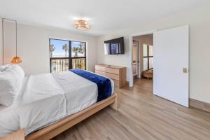 a bedroom with a large bed and a mirror at Saida II Beachfront Oasis in South Padre Island