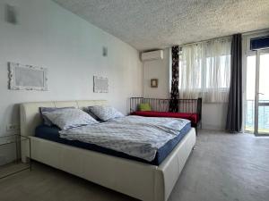 a bedroom with a bed and a large window at Apartment Kuk in Split