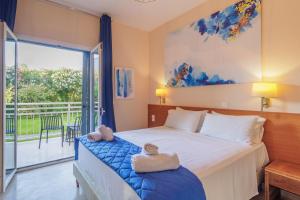 Postel nebo postele na pokoji v ubytování Primavera Hotel
