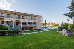 a large house with a yard and a pool at Primavera Hotel in Dassia
