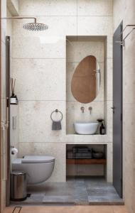 bagno con lavandino bianco e specchio di Viva Mare Studios a Astypalaia Town