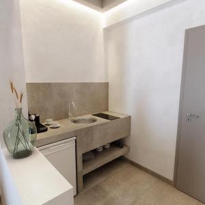 a bathroom with a sink and a counter at Viva Mare Studios in Astypalaia Town