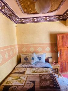 A bed or beds in a room at Gite Tawada