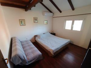 a bedroom with two beds and a window at Apartment Martina in Rab