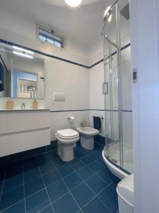 a bathroom with a toilet and a sink and a shower at WildSunset in Monte Argentario