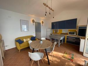 a kitchen and living room with a table and a couch at WildSunset in Monte Argentario +35 photos