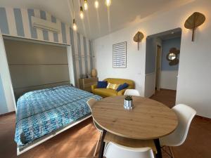 a bedroom with a bed and a wooden table at WildSunset in Monte Argentario