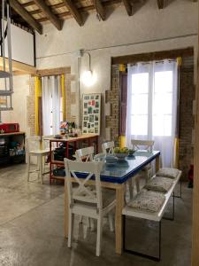 a dining room with a blue table and chairs at La Auténtica in Valencia