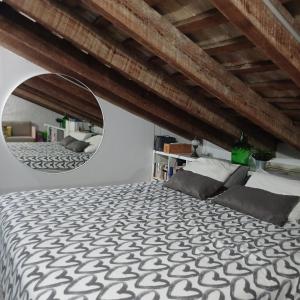 a bedroom with a large bed and a mirror at La Auténtica in Valencia