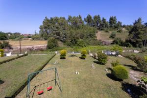 an aerial view of a park with people laying on the grass at The Emerald Garden Maisonette in Siviri