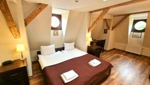 - une chambre avec un lit et 2 serviettes blanches dans l'établissement Hotel Charlotta, à Jedlina-Zdrój