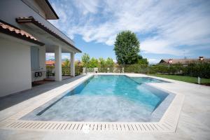 a swimming pool in the backyard of a house at Exclusive Villa le Palme in Polpenazze del Garda