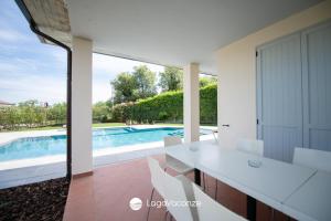 a view of the swimming pool from the kitchen of a house at Exclusive Villa le Palme in Polpenazze del Garda