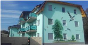 a building with birds painted on the side of it at Monteure sind HERZLICH WILLKOMMEN! in Mittenwalde