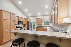 a kitchen with wooden cabinets and a large counter top at Suncrest Hideaway in Whitefish