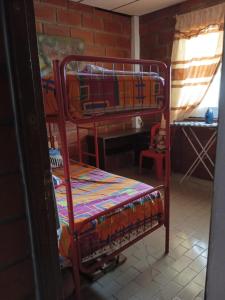 a room with two bunk beds and a desk at A orillas del paraiso in Playas