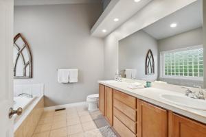 a bathroom with a tub and a sink and a toilet at Suncrest Hideaway in Whitefish +23 photos