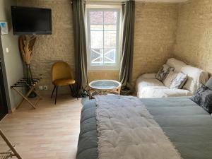 Letto o letti in una camera di Chambres d’hôtes de l’Ancienne Auberge