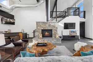 a living room with a fireplace and a table at Quarry A21 in Whitefish