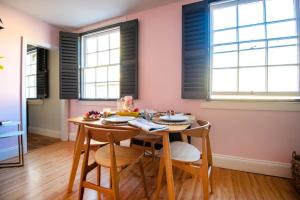 a dining room with a table and chairs and windows at Dream Stays Bath - Haringtons Place in Bath