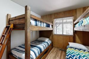 a bedroom with two bunk beds and a window at Mountain Charm in Homewood