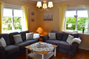 a living room with couches and a coffee table at Hus Vena in Vena