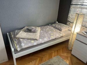 a bed with a blanket and a towel on it at Apartment Ortakovski in Skopje