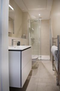 uma casa de banho com um lavatório branco e um chuveiro em Dream Stays Bath - John Street em Bath