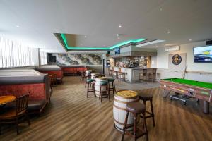 a restaurant with a pool table and a bar at Hardgate House Hotel in Clydebank