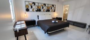 a bedroom with a bed and a table in it at Furna Blue View in Lagoa