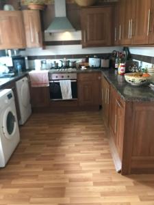 a kitchen with a stove and a dishwasher at 31 Stonelea court in Meanwood