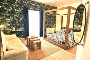 a living room with a bed and a couch at La Belle Maison in Avèze