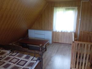 A bed or beds in a room at Domek u Heleny