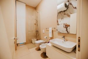 a bathroom with a sink and a toilet at Villa Splendid Palase in Himare +31 photos