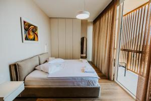 a bedroom with a bed and a large window at Villa Splendid Palase in Himare