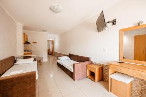 a hotel room with a couch and a mirror at Hotel Marialena in Potos