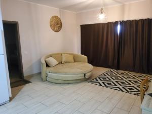 sala de estar con silla y cortina en Aldau Heights, en Hurghada