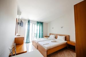 a hotel room with two beds and a window at Hotel Marialena in Potos +54 photos
