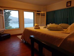 a bedroom with a bed with a view of the water at Elies Apartments in Alinda