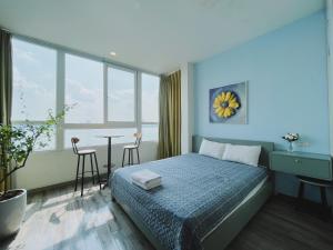 a bedroom with a bed and a table with chairs at Hanoi Home 2 - Lake View Apartment in Hanoi