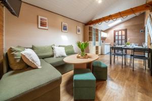 a living room with a couch and a table at MAX Apartamenty - Pokoje - Domki - Restauracja - Basen in Mielno