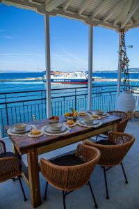 a table with food on it with a view of the ocean at Lalaros Apartment in Glóssa