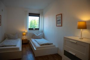Un pat sau paturi într-o cameră la Ferienhof Kruse Wohnung Nr 5