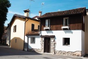 a white building with a brown roof at Casa Antica Pietra Spilimbergo in Spilimbergo