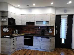 a kitchen with wooden cabinets and a counter top at Little Gem in Binningen