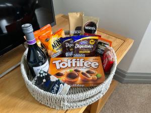 a basket filled with snacks and a bottle of wine at No.3 in Cardiff