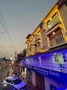 a building with blue lights on it on a street at Hotel Sai Advika in Mapusa