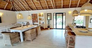 a kitchen with a large island in a room at Sunset Villa - Beachfront Villa with Private Pool by Karula in Cabo Nhamua