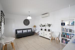 a living room with a couch and a table and chairs at Anixi Hotel in Ornos