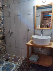 a bathroom with a sink and a shower at Maison adorée in Nea Vrasna